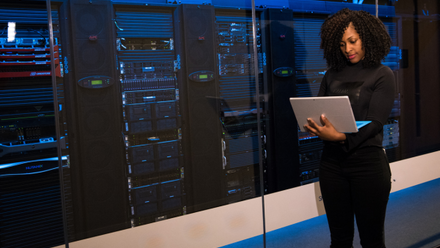 Woman on computer in data centre