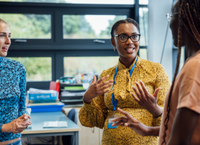 Three women standing and talking