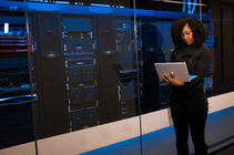Woman on computer in data centre