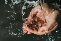 Two hands shown in water