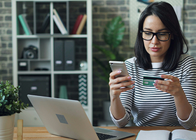 Woman using a credit card to pay online