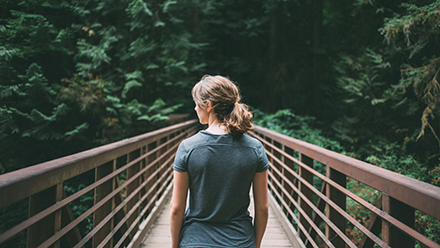 Woman stood on a bridge