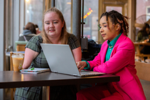 Disabled woman getting help from a woman