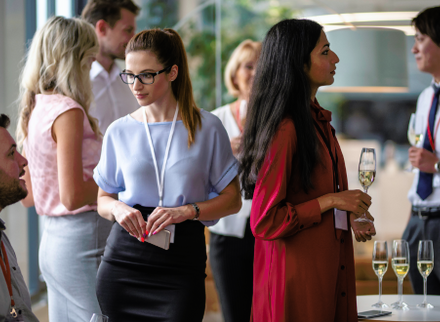 People discussing with a drink