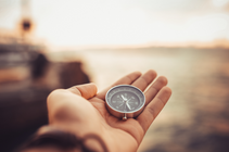 Hand holding a compass
